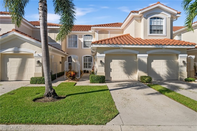 mediterranean / spanish-style home with a garage and a front yard