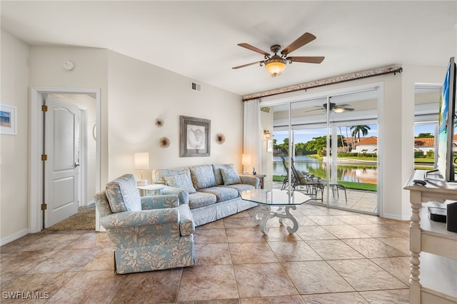 living room with a water view and ceiling fan