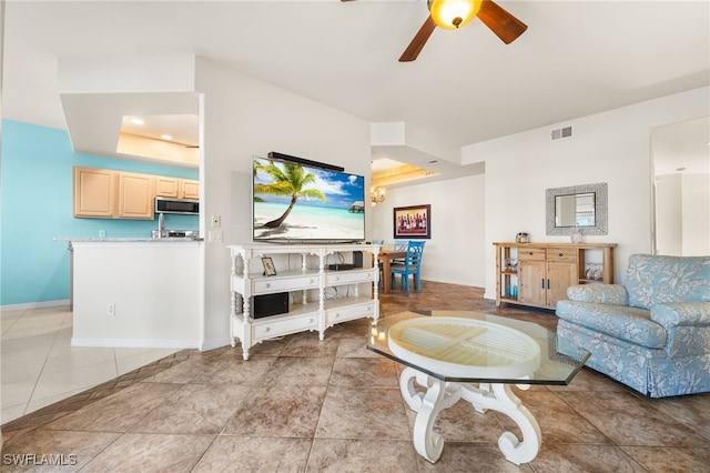 living room with ceiling fan and light tile patterned flooring