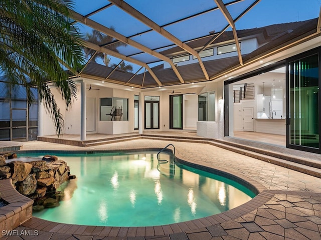 view of pool with a patio, ceiling fan, and a lanai