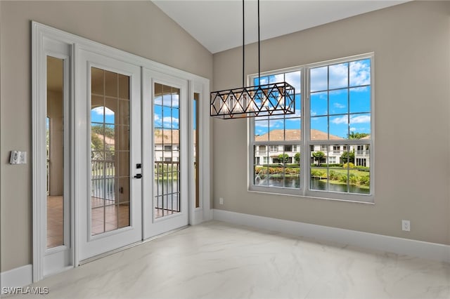 unfurnished dining area featuring a water view and french doors