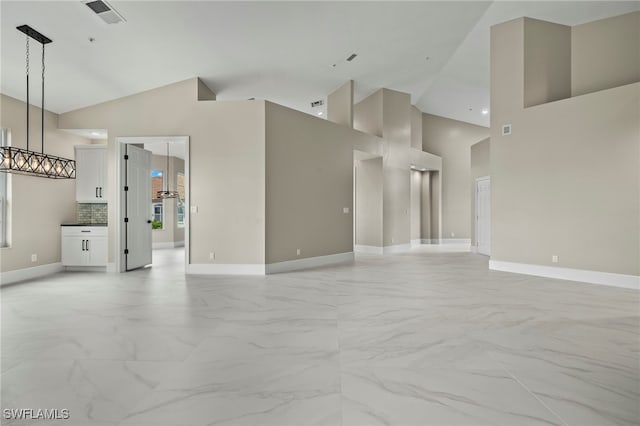 164 Colonade Cir Unit 1307, Naples, FL 34103 - unfurnished living room with high vaulted ceiling, marble finish floor, and visible vents