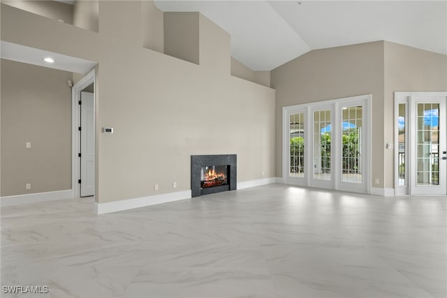 unfurnished living room with high vaulted ceiling