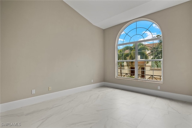 spare room featuring vaulted ceiling