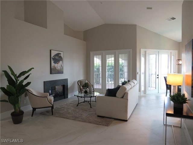 living room featuring a multi sided fireplace and high vaulted ceiling