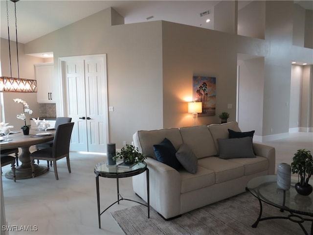 living room with high vaulted ceiling