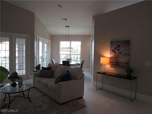 living room with vaulted ceiling and french doors