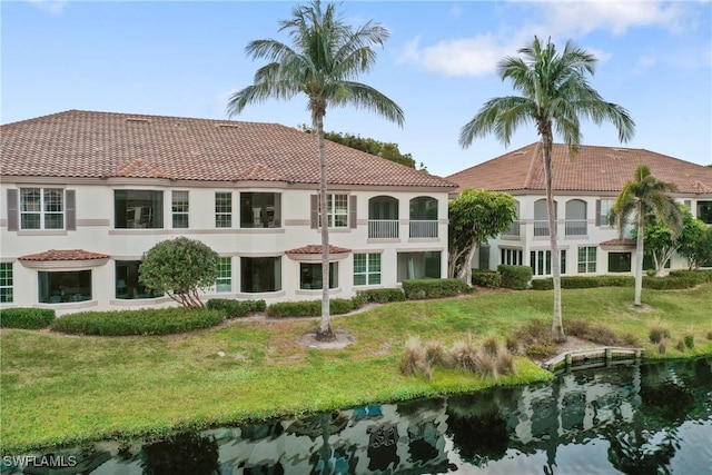 164 Colonade Cir Unit 1307, Naples, FL 34103 - rear view of house with a tiled roof, stucco siding, and a yard