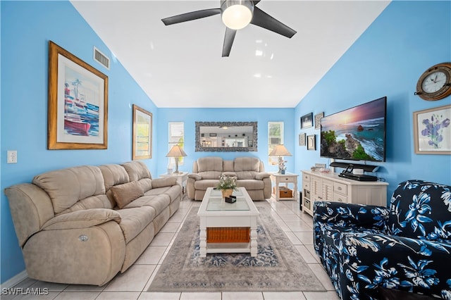 living room with ceiling fan, light tile patterned flooring, and vaulted ceiling