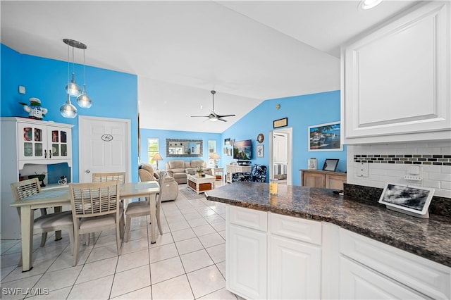 kitchen featuring ceiling fan, light tile patterned floors, white cabinetry, and vaulted ceiling