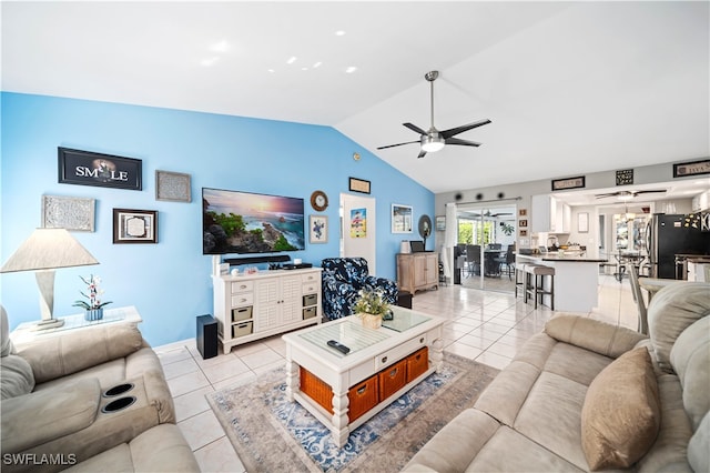 tiled living room featuring lofted ceiling and ceiling fan