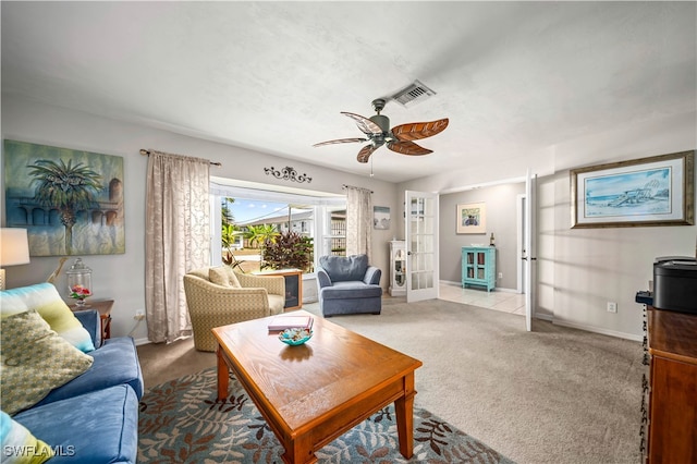 carpeted living room featuring ceiling fan and french doors