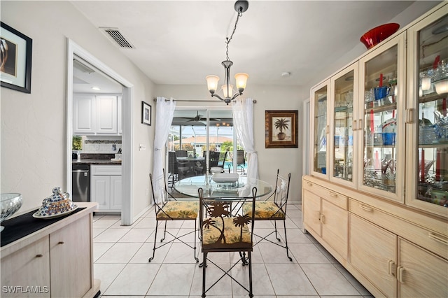 dining room featuring a chandelier and light tile patterned floors