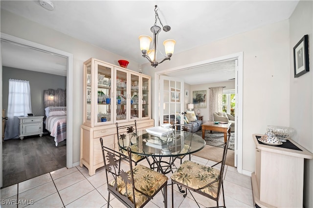 dining space with light wood-type flooring and a chandelier