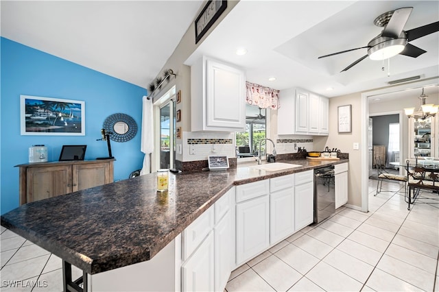 kitchen featuring ceiling fan with notable chandelier, dishwasher, backsplash, sink, and white cabinets