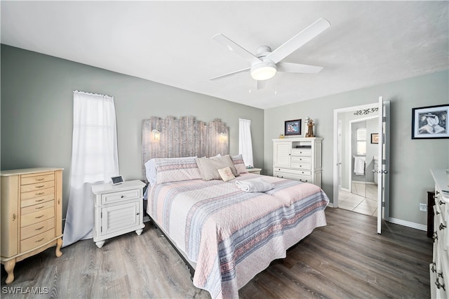 bedroom featuring ceiling fan, dark hardwood / wood-style floors, and ensuite bath