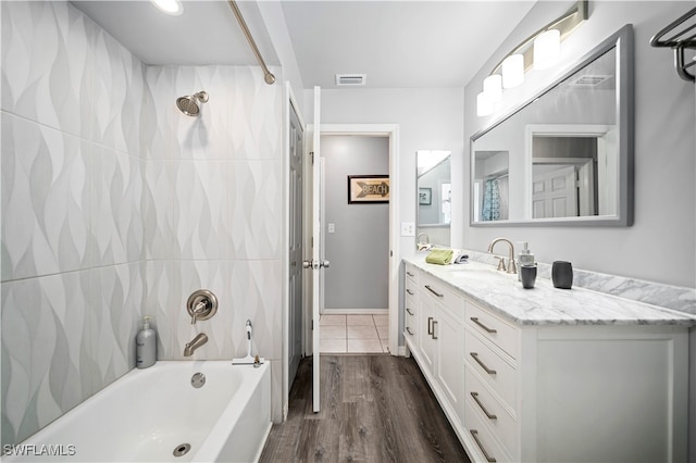 bathroom with vanity, shower / tub combination, and hardwood / wood-style floors