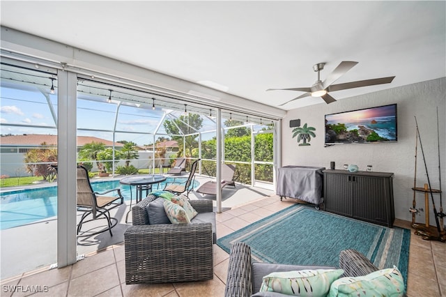 living room featuring ceiling fan and light tile patterned floors