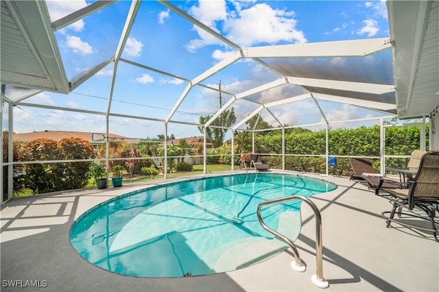 view of swimming pool with a lanai and a patio area