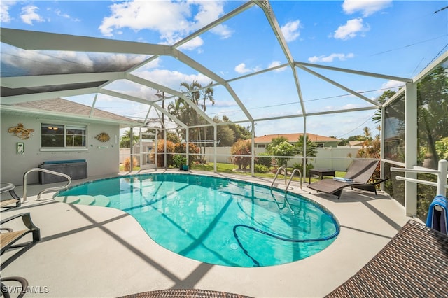 view of swimming pool featuring a patio and a lanai