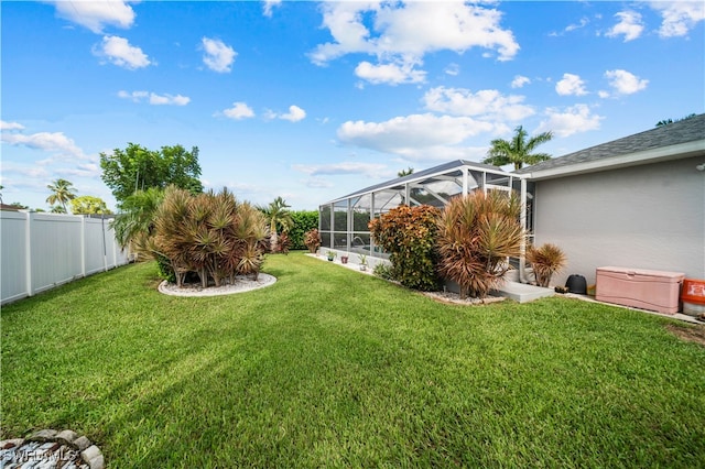 view of yard featuring glass enclosure