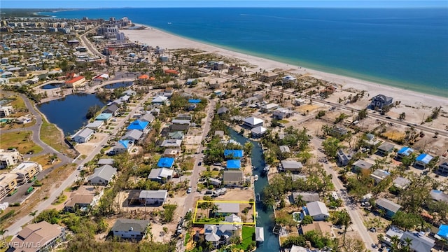 birds eye view of property featuring a residential view, a water view, and a beach view