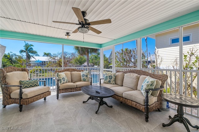 sunroom featuring ceiling fan