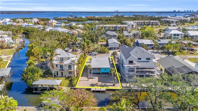 birds eye view of property with a water view and a residential view