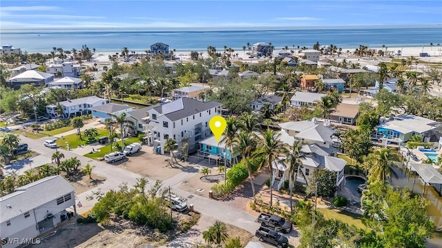 drone / aerial view with a water view and a residential view