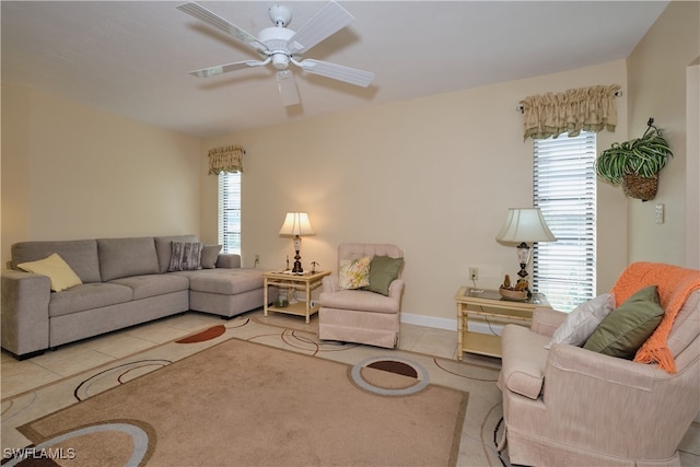 tiled living area with a ceiling fan, baseboards, and a wealth of natural light