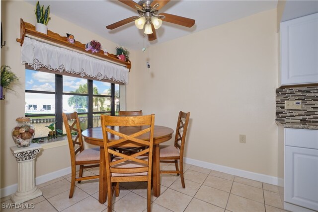 dining space with light tile patterned floors and ceiling fan