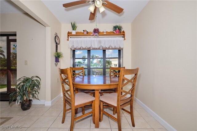 dining space featuring light tile patterned floors and ceiling fan