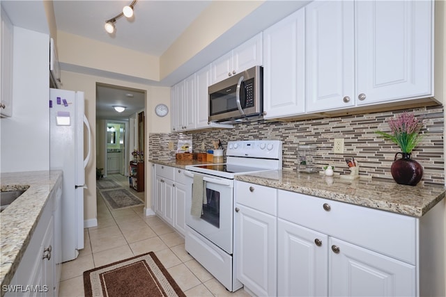 kitchen with backsplash, light tile patterned floors, white cabinetry, and white appliances