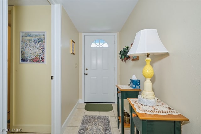 foyer featuring light tile patterned floors and baseboards