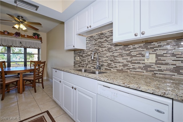 kitchen with light tile patterned floors, backsplash, a sink, visible vents, and white dishwasher
