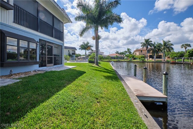 dock area featuring a water view and a yard