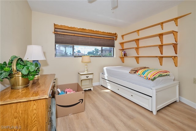 bedroom featuring baseboards and light wood-style flooring