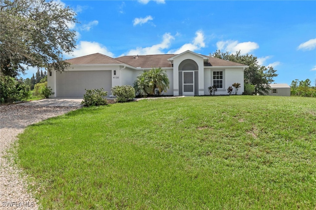 single story home featuring a front lawn and a garage