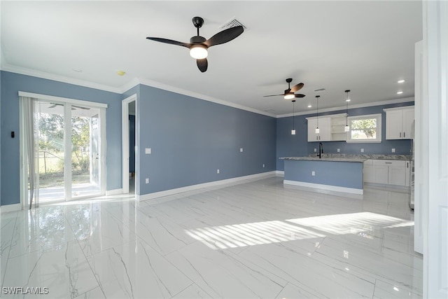 unfurnished living room with crown molding and ceiling fan