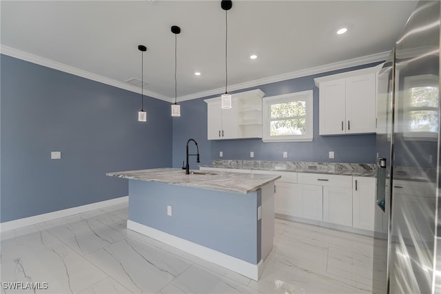 kitchen with sink, stainless steel fridge, white cabinets, and decorative light fixtures