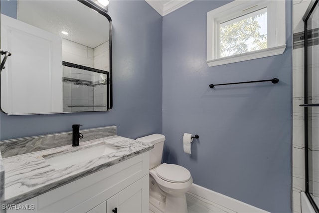 bathroom with vanity, toilet, and a shower with door