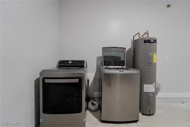 laundry room with separate washer and dryer and water heater