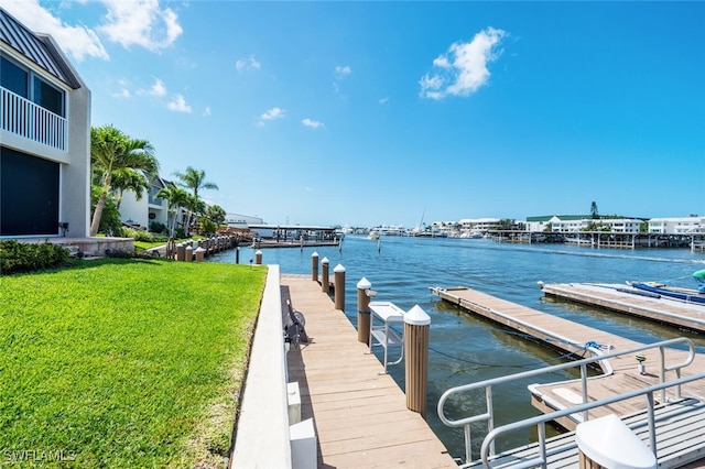 dock area featuring a water view and a yard