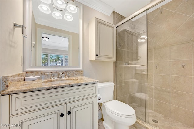 bathroom with crown molding, vanity, toilet, and a shower with shower door