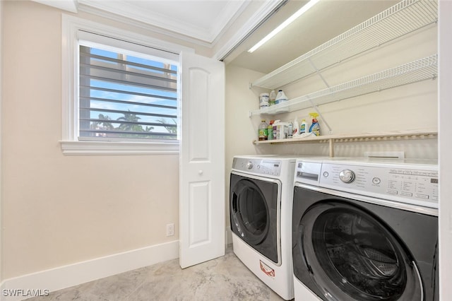 washroom featuring ornamental molding and washer and dryer