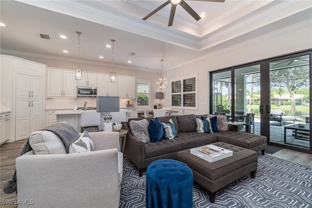 living room with french doors, wood-type flooring, crown molding, and ceiling fan