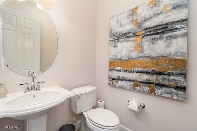 bathroom featuring toilet and sink