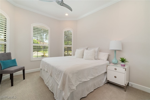 carpeted bedroom with crown molding and ceiling fan