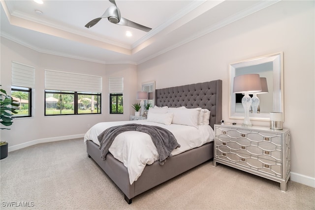 bedroom featuring crown molding, ceiling fan, a raised ceiling, and light carpet