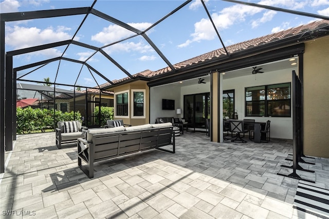 view of patio / terrace featuring glass enclosure, ceiling fan, and an outdoor hangout area